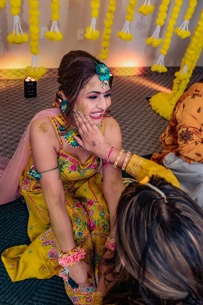 A bride mid-laugh at her haldi