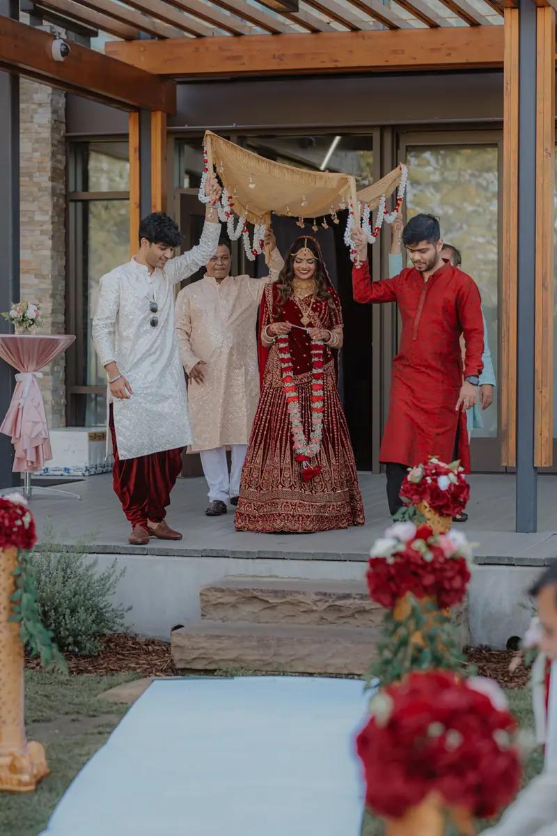 The bride arrives beneath a phoolon ki chadar