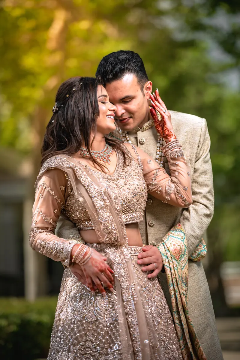 A tender embrace between the newlyweds at golden hour