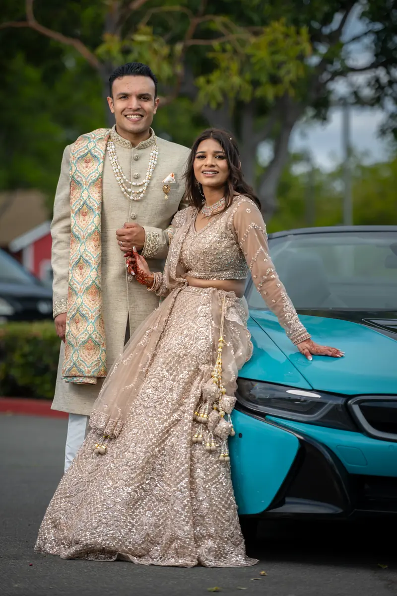 A couple portrait beside a sports car
