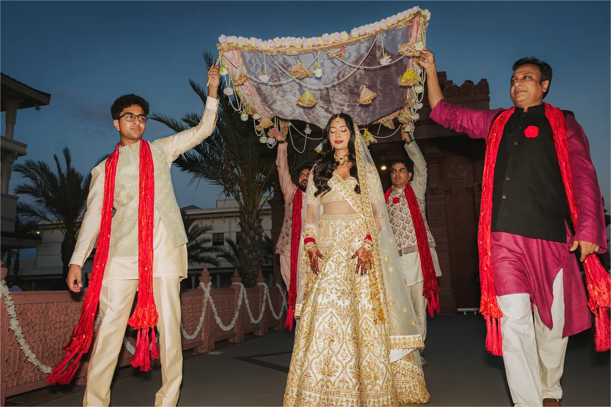 The bride carried in beneath the canopy