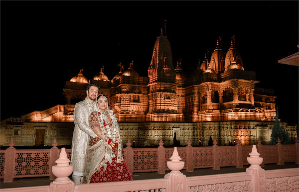 An embrace, the temple gold behind them