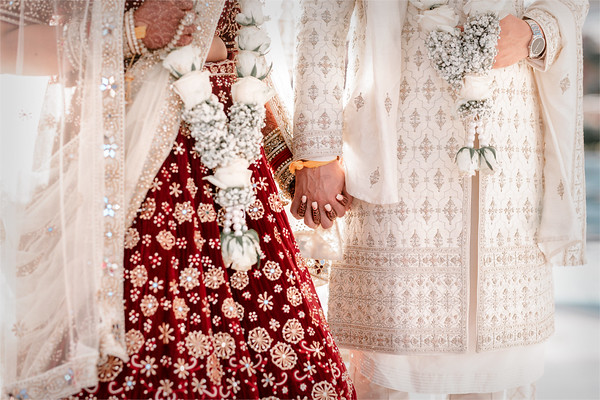 Hands joined, garlands between them