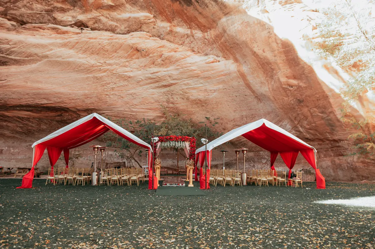 Red pavilions beneath the cliff