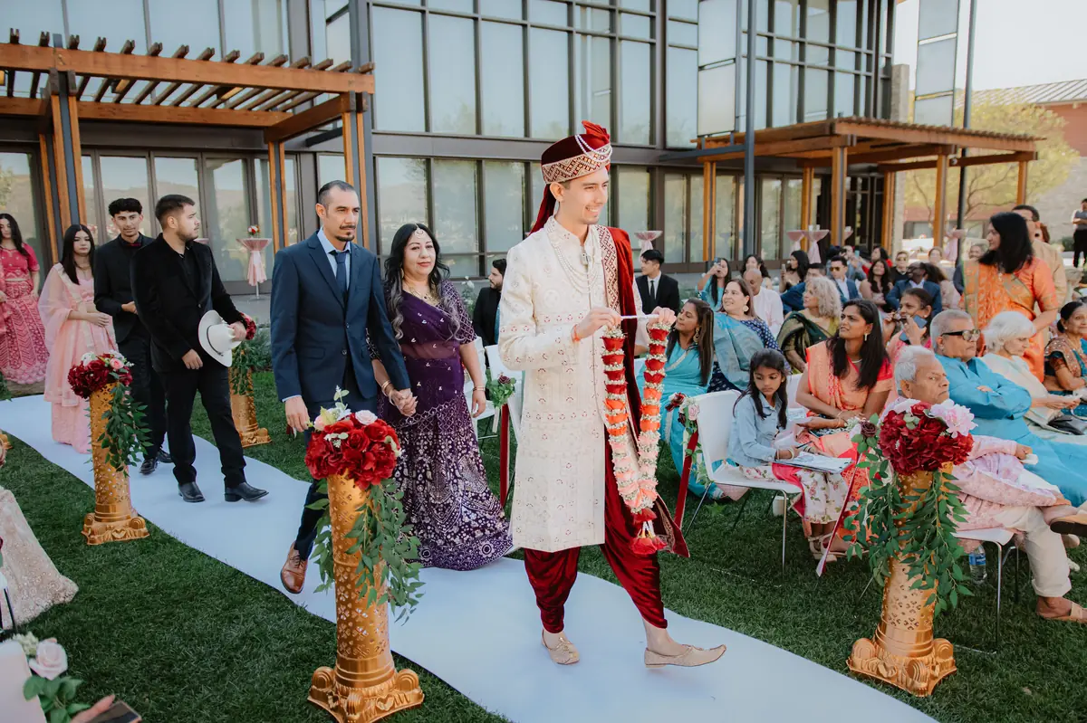 The groom walks the aisle
