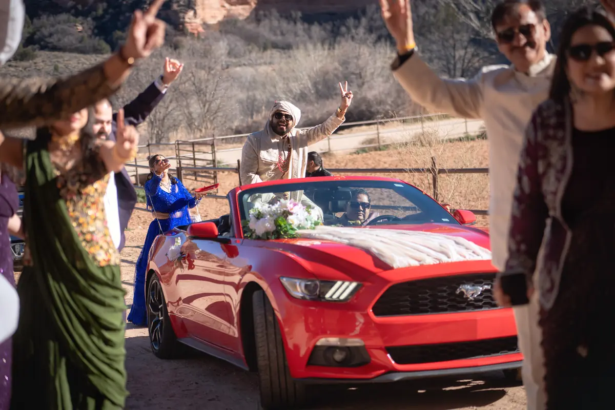 The red convertible pulls away