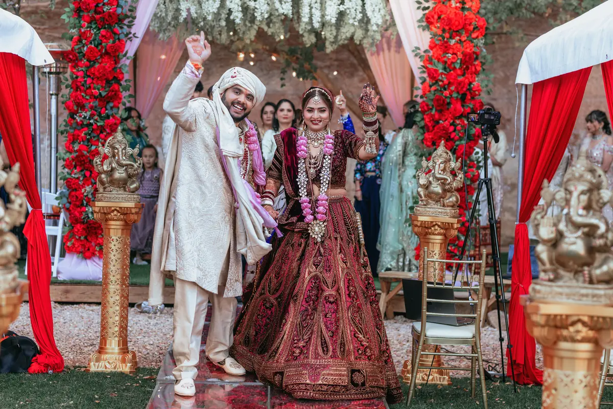 The couple celebrating, garlands on