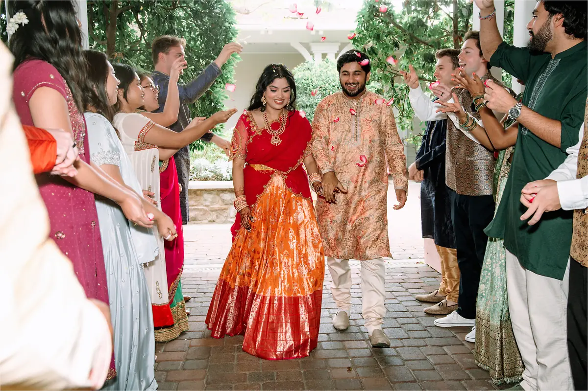 The couple enters through falling petals
