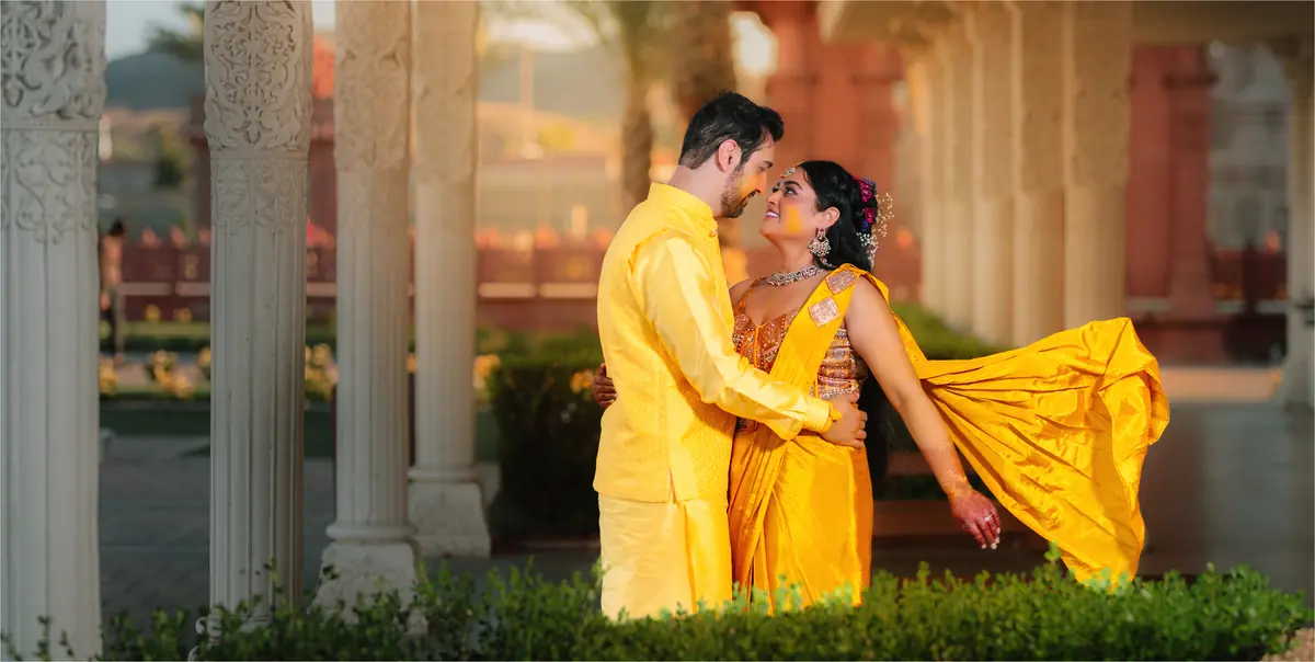 A haldi couple in the courtyard at golden hour